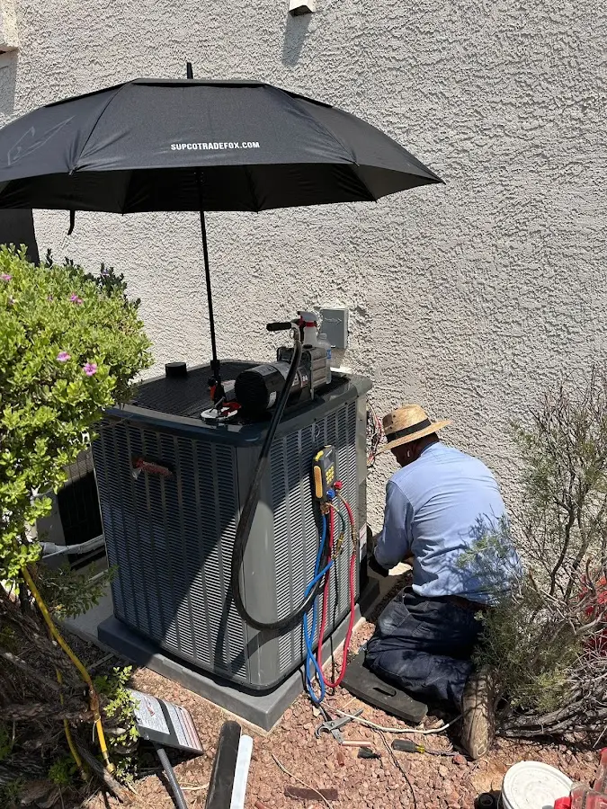 HVAC technician performing outdoor AC maintenance in Pataskala